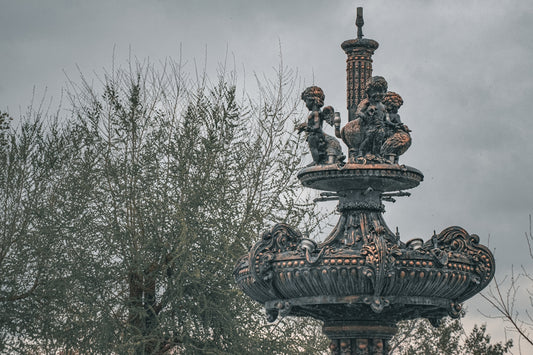 a water fountain with statues on top of it